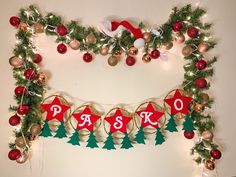 a christmas garland with ornaments hanging from it's sides and the word phi on it