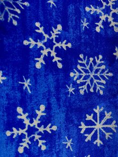 a blue and white snowflake pattern on fabric