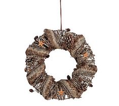 a christmas wreath hanging from a wire with pine cones and star decorations on the front