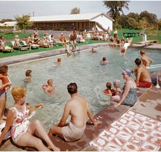 many people are sitting in the pool and swimming