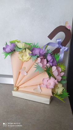 an arrangement of flowers on top of a book with the letter d in the background