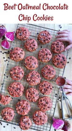 chocolate chip cookies on a cooling rack with purple flowers in the background and text overlay that reads beet oatmeal chocolate chip cookies