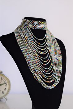 Unique African Maasai Handcrafted Beaded Necklace with an Elegant Look and Brilliant Finish. Color = Grey and Multi Color Beads. Length (Around Neck) = Adjustable Length. Length ( Downwards ) = 5.5 Inches / 14 cm. **GET FREE SHIPPING FOR ADDITIONAL ITEMS PURCHASED. Yes, Buy Multiple Items and pay shipping for 1 item only- The rest ships Free. (No Limits on the number of Multiple items). With a faster delivery time of 3 days via DHLExpress, Worldwide. Ordinary/Standard Shipping also available upo Multicolor Polished Beads Choker Jewelry, Multicolor Beaded Chain Choker For Party, Multicolor Polished Bead Choker Jewelry, Multicolor Dangling Beads Choker Jewelry, Multicolor Polished Beads Choker, Multicolor Polished Bead Choker, Party Multicolor Beaded Chain Choker, Festival Multicolor Polished Beads Choker, Multicolor Beaded Choker With Dangling Beads