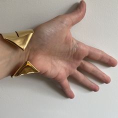 A lighter cuff on the repertoire. I have created this piece out of a single sheet of metal. It is completely formed and can be worn showing the ends on the front or the wide strip on the front. ~1.5" wide ~fabricated out of a single brass sheet and finished in 14k nickel free gold plating Bracelet is light and can be adjusted to fit the wrist. Slip on gently due to the ends but adjust by softly squeezing to fit around your wrist a little less loosley. Bold, unique and sculptural jewelry, handmad Contemporary Metal Cuff Bracelet, Modern Yellow Gold Cuff Bracelet For Party, Gold Open Cuff Bracelets For Party, Yellow Gold Cuff Bracelet For Party, Gold Open Cuff Bracelet For Party, Party Yellow Gold Cuff Bracelet, Unique Hand Forged Cuff Bracelet For Formal Events, Unique Cuff Bracelet For Formal Occasions, Unique Hand Forged Cuff Bracelet For Formal Occasions