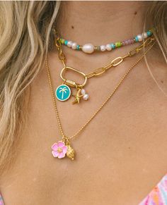 The Hibiscus Necklace is the necklace of the summer! The bright enamel Hibiscus charm paired with a gold conch shell on a ball chain is the perfect representation of the whimsical free spirit of summertime. 24k gold plated tarnish free 19” Cheap White Charm Necklaces For The Beach, Cheap Casual Summer Shell Necklace, Cheap Beachy Shell Necklace As A Gift, Summer Vibe Jewelry, Cheap Playful Beach Necklaces, Cheap Adjustable Necklaces With Starfish Charm, Luxury Shell-shaped Beach Necklaces, Preppy Gold Necklaces, Small Business Jewelry Photography