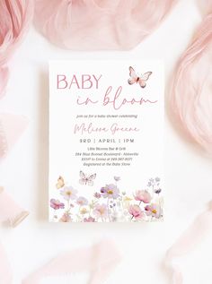 a baby shower is shown with pink flowers and butterflies