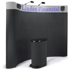 a black and white trade show booth with a sign that says linden financial on it