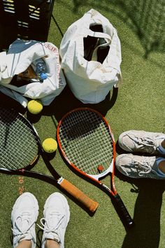 two tennis rackets and shoes on the ground