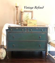 an old dresser is painted green with the words vintage refreshed on it's side