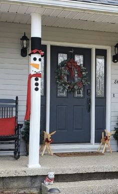 a front porch decorated for christmas with snowman decorations