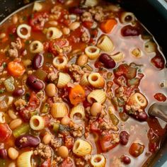 a large pot filled with pasta and vegetables