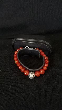 "This handmade Genuine Carnelian Beaded Bracelet was made on Silver Wire with round Genuine Carnelian Ball Beads. At each end are a 925 lobster clasp and jump ring. At the center is medium size Silver Ornate Metal Ball that is the focal point. This bracelet was handmade by Dulcinea for a small wrist and all items used are new. This bracelet will arrive in a gift box with FREE SHIPPING. Measure: 6 5/8\" L Material: Genuine Carnelian in Round Shape, 925 Lobster Clasp and Ornate Round Metal Ball Ha Carnelian Round Beads Bracelet For Gift, Amber Round Beaded Bracelets With Natural Stones, Adjustable Carnelian Bracelet As A Gift, Adjustable Carnelian Bracelet Perfect For Gifts, Adjustable Carnelian Beaded Bracelets As Gift, Amber Carnelian Beaded Bracelets - Gift, Amber Carnelian Beaded Bracelet Gift, Hand-strung Round Amber Bracelets, Amber Bracelets With Natural Stones