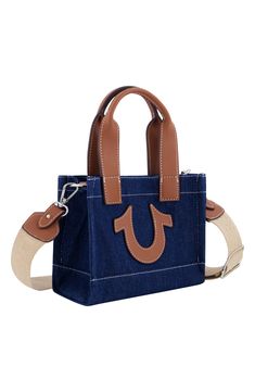 Contrast topstitching and the iconic winged logo bring a familiar finish to a squared denim tote bag topped with a trio of handles for convenient carrying. 8" H x 7" W x 4" D 5" handle drop, 25" strap drop Dual top handles, optional crossbody strap Textile and synthetic Lined Imported Rectangular Canvas Shoulder Bag With Logo Hardware, Shopping Canvas Bag With Logo Hardware, Shopping Bags With Logo Hardware On Canvas, Everyday Canvas Shoulder Bag With Logo Hardware, Casual Shoulder Bag With Logo Hardware For Everyday Use, Casual Tote Bag With Logo Hardware, Casual Rectangular Shoulder Bag With Logo Hardware, Casual Bags With Logo Hardware For Daily Use, Casual Shopping Bags With Logo Hardware