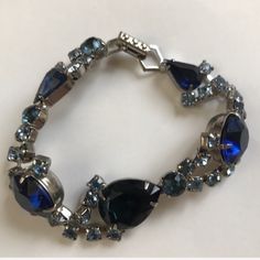 This Bracelet Is Absolutely Stunning! Pictures Do Not Do It Justice! - Perfect Condition - Dark And Light Blue Varying Crystals (Teardrop, Circular, Square) W Silver - Silver Hinge Clasp - Bracelet Missing No Stones, No Scratches (Never Worn) Blue Formal Bracelet Jewelry, Blue Costume Jewelry For Formal Occasions, Formal Blue Bracelet Jewelry, Vintage Blue Bracelet For Formal Occasions, Handmade Blue Jewelry For Evening, Elegant Blue Bracelets For Evening, Blue Sparkling Stones Bracelet For Formal Occasions, Blue Costume Jewelry Bracelets For Formal Occasions, Blue Round Crystal Bracelet For Formal Occasions