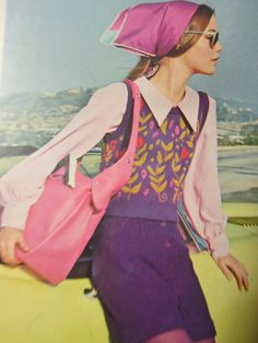 a woman wearing a pink hat and carrying a pink bag in front of a yellow car