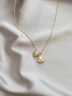 "△ DETAILS * 100% Genuine natural freshwater pearls, real pearl * Natural white color button shaped pearls, 5-5.5mm size, AAAA grade * 14K gold plated seashell/shell clam/oyster, with faceted cubic zirconia * 18K gold vermeil sterling silver chain, 18 inches (45cm) length * Delicate and daily wear necklace, perfect for yourself or as a gift * Ready for gifting, packed in a beautiful jewelry box * Handmade in USA ♥ Pearl Size: 5-5.5mm ♥ Pearl Shape: Button ♥ Pearl Color: White ♥ Chain Length: 18 Pearl In Shell Necklace, Pearl Clam Necklace, Cute Pearl Jewelry, Pearl Necklace With Pearl Charm For Mother's Day, Pearl Pendant Charm Necklace With Pearl Drop, Pearl Drop Pendant Charm Necklace, Gold Pearl Shell Necklace With Pearl Drop, Mother's Day Pearl White Necklace With Pearl Charm, Shell-shaped Pearl Necklace With Pearl Pendant