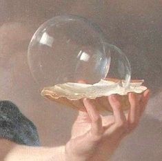 a person holding a bubble in their hand