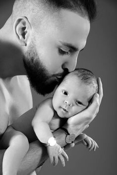 a man holding a baby in his arms