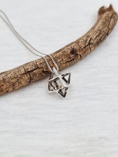 "MERKABA NECKLACE Material: 925 Sterling Silver 925 Sterling silver box chain, spring clasp. Pendant height: 0.65\" Width: 0.5\" The Star Tetrahedron is the energetic and geometric representation of the human body, male and female, heaven and earth, also called the Merkabah. . The word 'Mer' is translated into 'Light', 'Ka' refers to the spirit, while 'Ba' refers to the body or physical being. It is a common belief that the Merkabah is a representation of our energy system's shape in upper dimen Merkaba Necklace, Star Tetrahedron, Body Male, David Star, Heaven And Earth, Energy System, Silver Box, Box Chain, Sacred Geometry