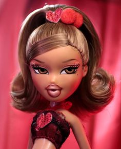 a close up of a barbie doll with long hair and big eyes wearing a red dress