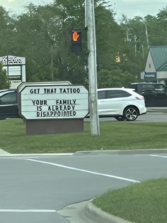 a sign that says get that tattoo your family is already disappointed