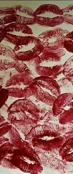 an image of a drawing with red ink on white paper that looks like fish in the water