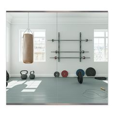 a gym room with exercise equipment in the foreground and a punching bag on the wall