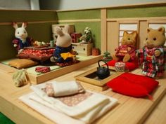 three toy mice sitting on top of a wooden table next to other toys and decorations