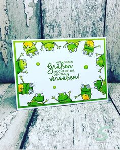 a card with some green frogs on it