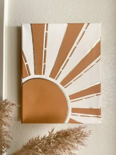 a brown and white painting sitting on top of a wall