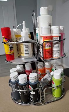 a metal container with many different types of paint on it's sides and two shelves