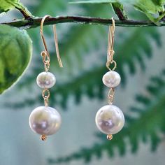 "MY GEMS ROCK Drop Length:1.5\"L. Description: A large and small white fresh water pearl wired together and hung on a sterling silver earring hook -Beautiful freshwater pearl earrings are an elegant and stunning accessory for any special occasion. -Hypo-allergenic rubber backing. https://www.etsy.com/shop/MYGEMSROCK" Dangle Pearl Earrings For Bridesmaid Gift, Pearl Dangle Earrings For Bridesmaid Gift, Wire Wrapped Pearl Earrings For Wedding, White Wire Wrapped Round Pearl Earrings, Dainty Wire Wrapped Pearl Earrings For Wedding, Adjustable White Pearl Earrings For Wedding, Anniversary White Pearl Chain Earrings, White Wire Wrapped Pearl Earrings For Wedding, Pearl Earrings For Anniversary With Ear Wire