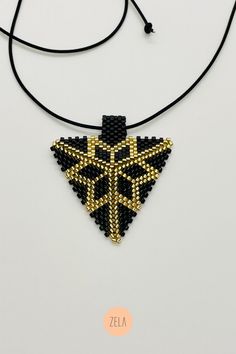 Handmade high-end geometric jewelry made with glass beads. Gift Choker With Round Gold Beads, Gift Gold Beads Round Choker, Gold Pendant Beads For Jewelry Making, Gift Beaded Gold Choker Necklace, Gift Gold Beaded Choker Necklace, Gift Gold Beads Choker Necklace, Gold Beads With Black Details As Gift, Gold And Black Beads As Gift, Gold And Black Beads Gift