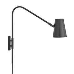 a black lamp on a white wall next to a light fixture with a gray shade