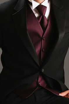 a man in a suit and tie is posing for the camera