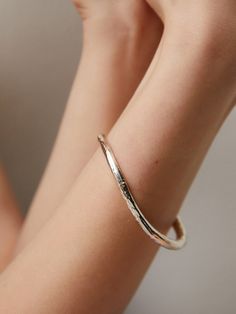 Editor's Notesgemma alus design presents a textured silver bangle. It is an excellent item to highlight your wrist and arm. - Textured bangle- Made of silver 925- Curved design- Causal and unique mood Measurements(in.)One Size- Size: 2.56 in. (W) * 2.09 in. (H) Composition & Care- Material: 925 Silver- Plated products may discolor over time due to their nature.- Please be careful that discoloration may proceed faster in chemical substances, water, and heat.- As all j Hammered Sterling Silver Bangle Bracelet, Hand Cast Sterling Silver Bangle Bracelet, Hand Cast Sterling Silver Bangle, Luxury Hammered Bangle Bracelet, Luxury Hammered Bangle, Elegant Hand Forged Bangle For Everyday Wear, Elegant Hand Forged Bangle For Everyday, Elegant Hand Forged Bangle Bracelet, Elegant Everyday Hand Forged Bangle