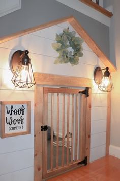 a baby gate in the corner of a room with two lights on top of it