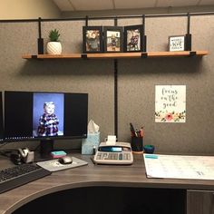 an office desk with two monitors and a keyboard