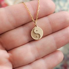 Our minimal tiny solid gold ying yang charm is just one of the many symbols represented in our Tiny Talismans line of spiritual jewelry and gifts. Available in 14k and 18k yellow rose and white gold, as well as platinum--just choose your desired metal from the drop-down menu!  More Tiny Talismans charm necklaces: http://etsy.me/2mtfeSO Details: - Made to order in NYC - Solid 14k, 18k gold or platinum - 11mm wide in diameter and 1.5mm thick. Contact us if you want bigger size. - Default finish is 14k Gold Spiritual Round Pendant Charm Necklace, Spiritual 14k Gold Charm Necklace With Round Pendant, 14k Gold Symbolic Charm Necklace With Round Pendant, Spiritual Round Charm Necklace In 14k Gold, Spiritual Round 14k Gold Charm Necklaces, Spiritual 14k Gold Round Charm Necklaces, Minimalist Personalized Jewelry For Meditation, Hypoallergenic Yellow Gold Spiritual Jewelry, Spiritual Round Charm Necklaces In Rose Gold