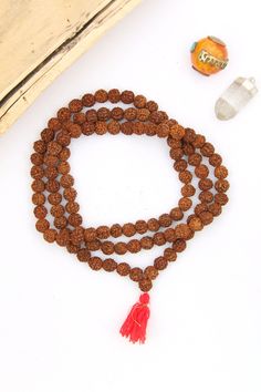 These meditation necklace is strung from Rudraksha seeds. Hailing from India, Rudraksha seeds are traditionally used as prayer beads in Hinduism and Buddhism. They are the seeds of the Rudraksha tree, and legend has it that when Lord Shiva awoke from a long meditation, he shed a tear; from this tear grew the Rudraksha tree.This is an authentic prayer bead necklace, complete with a guru bead and 108 beads; 108 is a significant number for various reasons, but it is believed that one must overcome Spiritual Necklaces With 8mm Beads For Rituals, Spiritual Gemstone Beads Mala For Puja, Spiritual Gemstone Mala For Puja, Spiritual Mala With Gemstone Beads For Festivals, Spiritual Beaded Necklace With 108 Beads For Festivals, Festival Gemstone Beads Mala For Meditation, Spiritual Beaded Necklace For Festivals, Spiritual Round Beads Mala For Puja, Spiritual Mala With Round Beads For Puja