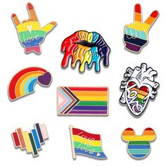 several pins with different colors and designs on them, including one in the shape of a heart