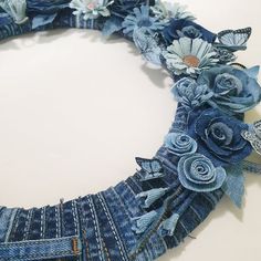 a blue jean necklace with flowers and butterflies on it