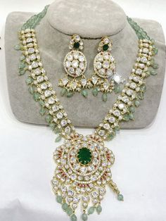 Kundanjewelsbyshiv Indian Ethnic Polki Kundan Golden Set With 22 Carat Gold Plated Necklace Set * This Set Is made up with High Quality Polki Kundan * Gold Plating Is used * High Quality Drops  Are used * Set includes Double Layered Necklace and earrings *Necklace Length Is Adjustable With Back Chain/Cord Earrings Have Pushbacks We made Jewelry in pachi kundan /Ahemdabadi kundan/ Polki Kundan and made designs on order only , need at least 25 days to make ,to do customization as they are acceptab Elegant Multi-stone Jewelry For Diwali, Elegant Multi-stone Necklace For Diwali, Festive Round Gemstone Bridal Necklace, Festive Round Bridal Necklace With Gemstone, Festive Bridal Gemstone Necklace, Fusion Kundan Multi-stone Jewelry, Fusion Multi-stone Jewelry For Diwali, Traditional Emerald Necklace With Jewels For Wedding, Festive Bridal Necklace With Gemstones