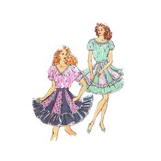 two women in dresses with ruffles on the bottom and one woman wearing a short dress