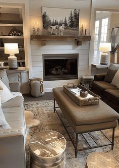 a living room filled with furniture and a fire place in the middle of a room