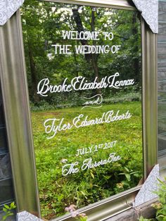 a large mirror with the words welcome to the wedding of brooke elizabeth lenna and her husband