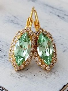 "Mint crystal earrings, Drop earrings, Bright green earring, Bridesmaid gifts, Bridal earring Dangle earrings wedding jewelry, gold or silver Elegant and refined. They would be great as bridal earrings or for any available other day. Perfect gift for bridesmaids or other occasions. They are made of 14k gold plated brass posts and European crystals, all set in prong setting. Made with CRYSTALLIZED™ - high quality genuine European (Austrian) crystals. Total earring's length is 30 mm (1.2 inch) AVA Green Crystal Bridal Earrings As Gift, Green Crystal Wedding Earrings With Ear Wire, Wedding Crystal Earrings For May Birthstone, Wedding May Birthstone Drop Crystal Earrings, Green Sparkling Stone Earrings For Gift, Green Drop Earrings For Bridesmaid Gift, Mint Crystal, Wedding Jewelry Gold, Green Earring