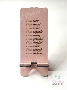 a pink stand with writing on it that says, i am kind of smart phone