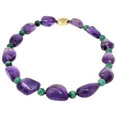 A modern circa 1980 beaded necklace by the Italian designer Tambetti featuring large nugget shape of natural amethysts alternated with round malachite beads. The clasp is designed to compliment the irregular shape of the amethysts, it is made in 18 karat polished yellow gold. The necklace weighs 188 grams and 21 inches long. Miriam Haskell Jewelry, Natural Gemstone Necklace, Violet Color, Miriam Haskell, Bridal Jewellery Indian, Amethyst Jewelry, Italian Designer, Gemstone Necklace, Indian Jewelry