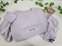 Welcome to our cozy world of comfort and relaxation! Our embroidered sweatshirt is the perfect addition to your wardrobe or makes a great gift for a loved one. - Embroidered sweatshirt - Embroidered to order - High cotton fabric content for the softest feel fabric. 80% Cotton/20% Recycled Polyester. Brushed back fleece. - Unisex sizing for ultimate comfort. Drop shoulder. - Order size up for an over-sized look. - Treat yourself or surprise someone special Hoodies and sweatshirts are embroidered Trendy Letter Embroidery Sweatshirt For Loungewear, Embroidered Relaxed Fit Sweatshirt For Gift, Embroidered Cotton Sweatshirt For Loungewear, Embroidered Relax Fit Sweatshirt For Gift, Cozy Cotton Sweatshirt With Embroidered Text, Embroidered Relaxed Fit Sweatshirt As Gift, Embroidered Text Sweatshirt For Loungewear, Loungewear Sweatshirt With Embroidered Text, Custom Embroidery Relaxed Fit Sweatshirt For Loungewear